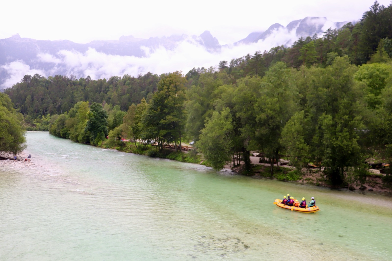 Glide through Bled, Slovenia's emerald waters on a serene rafting adventure amidst lush forests and majestic mountains.